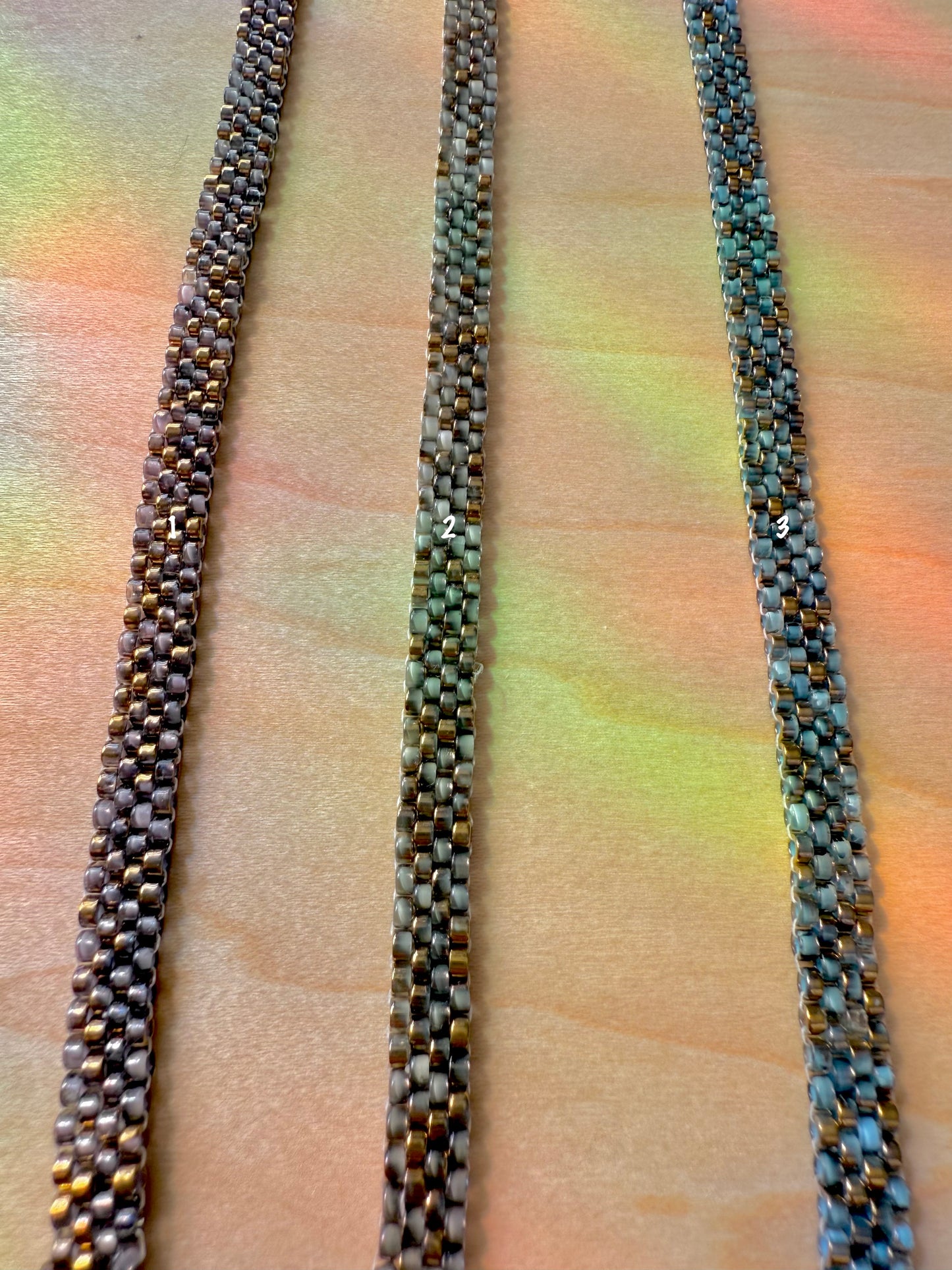 Three woven ropes of different colors on a textured surface