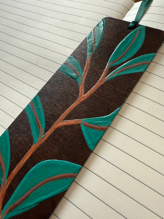 Wooden bookmark with leaf design on lined notebook pages