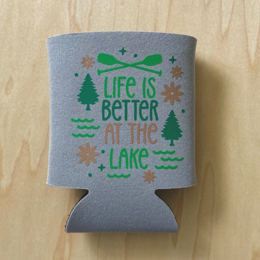 Gray can cooler with 'Life is Better at the Lake' text on a wooden surface