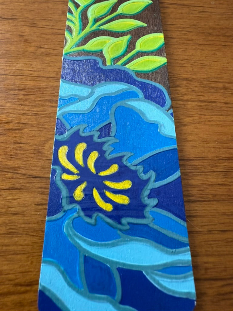 Colorful bookmark with floral design on a wooden surface