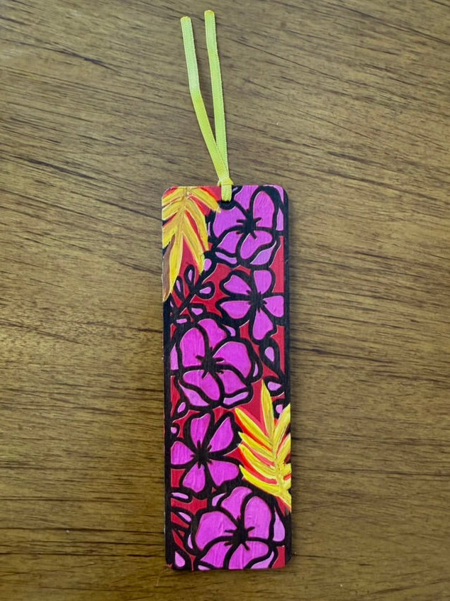 Colorful floral bookmark on a wooden surface
