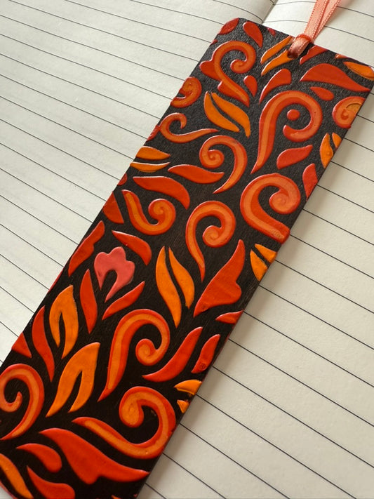Decorative orange and black patterned bookmark on lined paper
