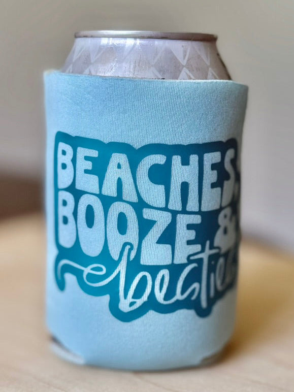 Can cooler with 'Beaches Booze & Boogies' text on a wooden surface