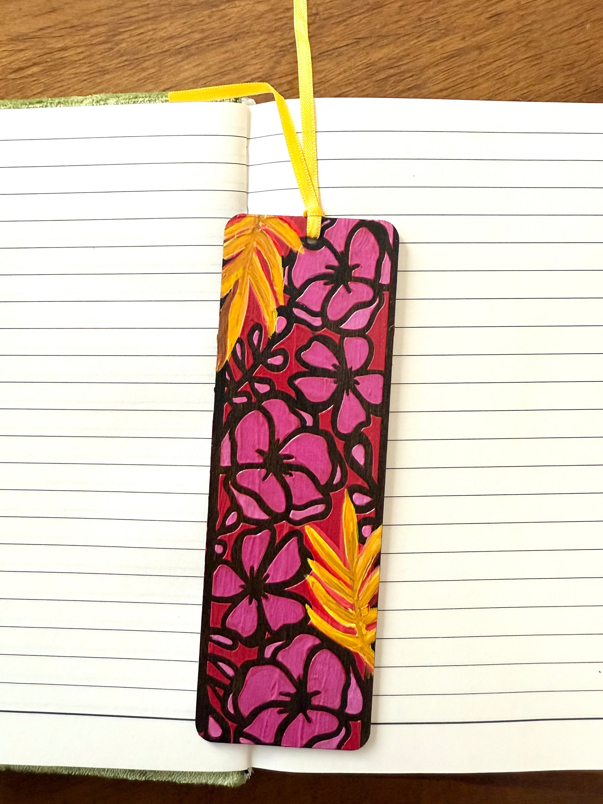 Floral bookmark with pink and yellow design on a notebook page