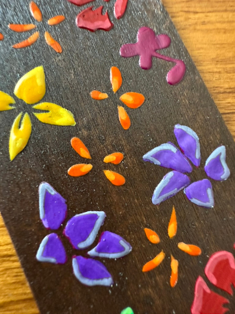 Colorful flower-shaped objects on a dark surface