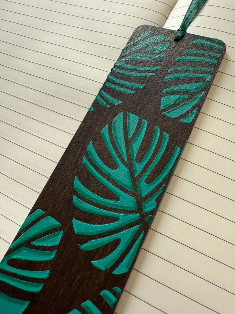 Bookmark with green leaf pattern on a lined notebook page
