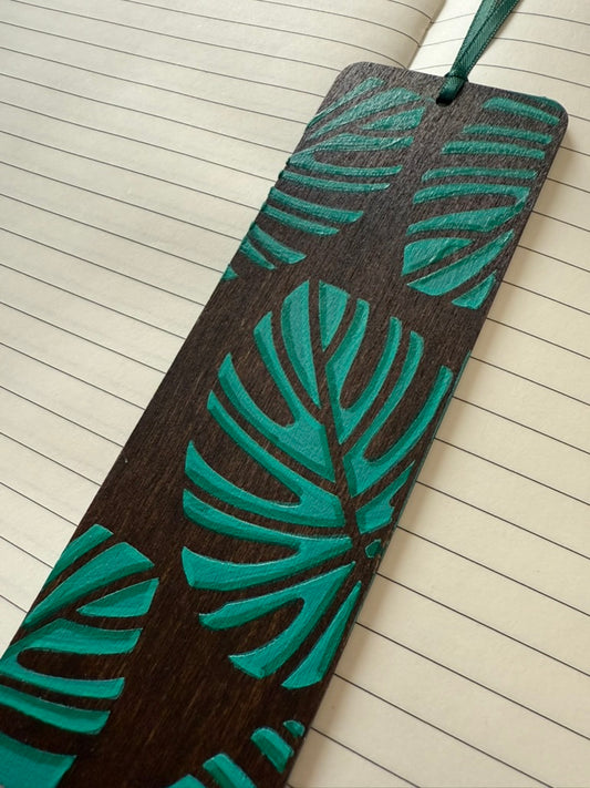 Bookmark with green leaf pattern on a lined notebook page