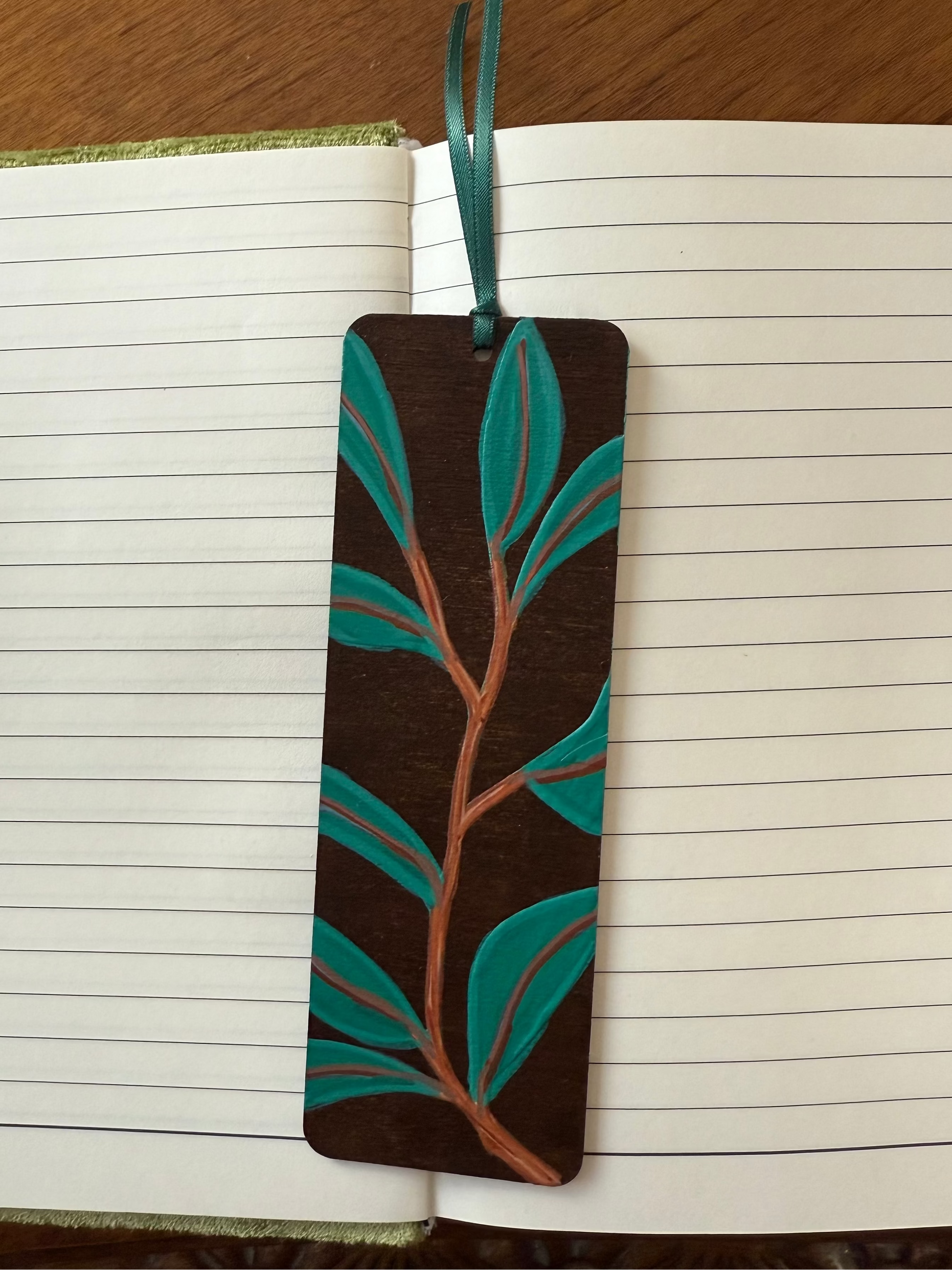 Bookmark with leaf design on an open notebook