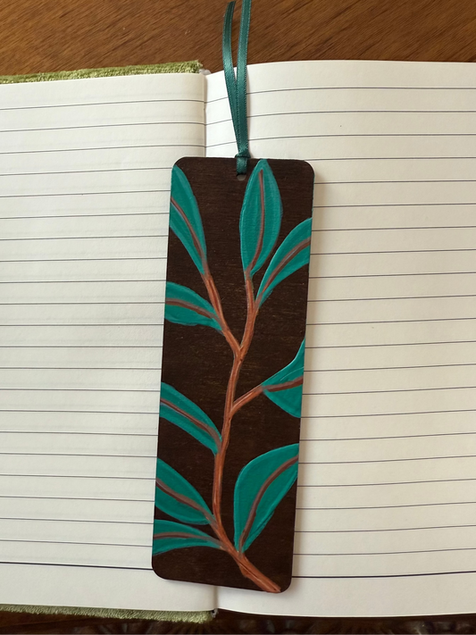 Bookmark with leaf design on an open notebook
