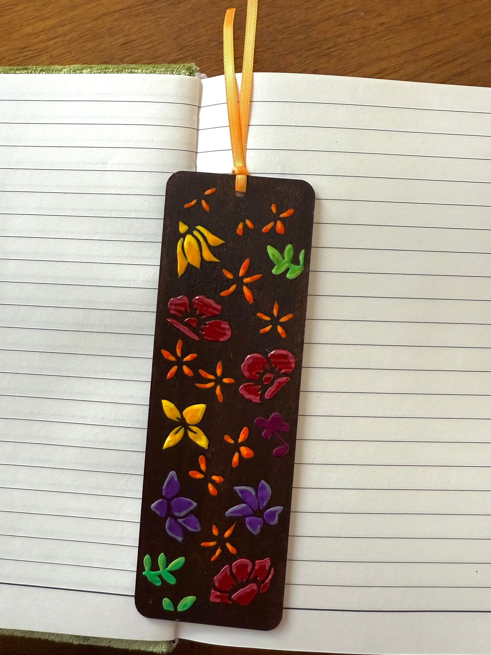 Decorative bookmark with floral patterns on a notebook page