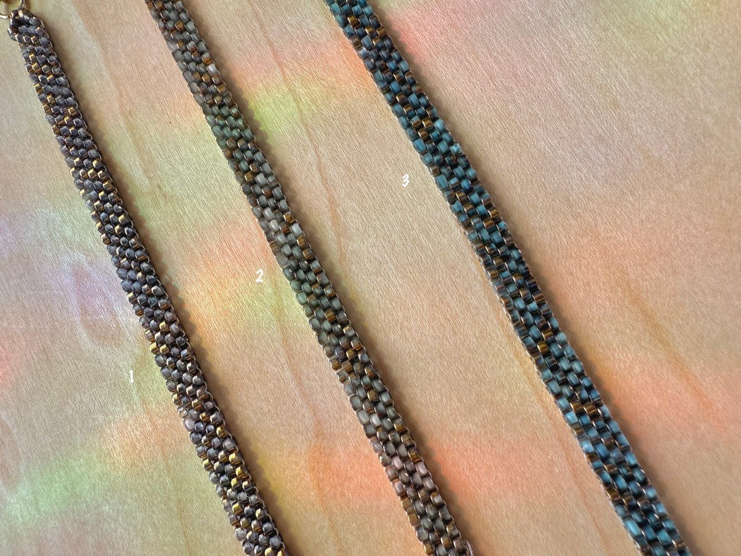 Close-up of a textured black and brown cord on a multicolored fabric background