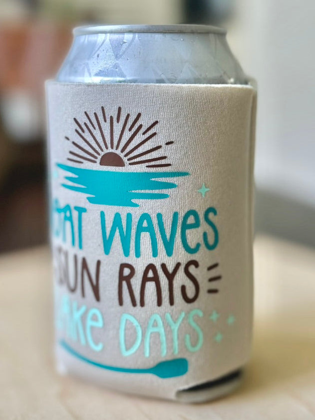 Can cooler with 'Waves Sun Rays Make Days' text on a wooden surface
