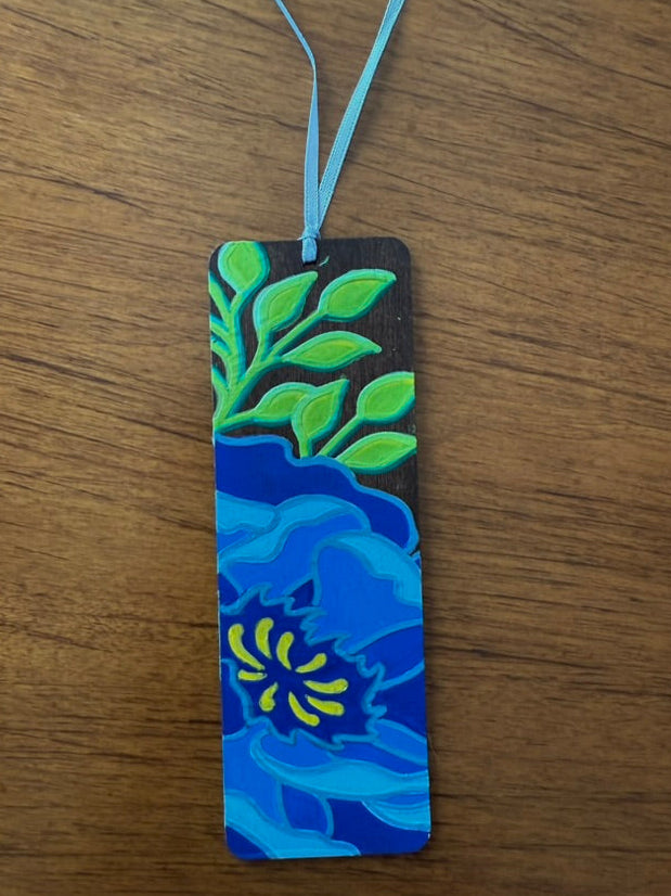 Colorful bookmark with floral design on a wooden surface