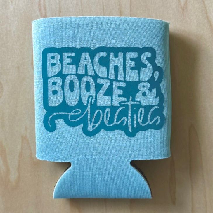Blue can cooler with 'Beaches, Booze & Bees' text on a wooden surface