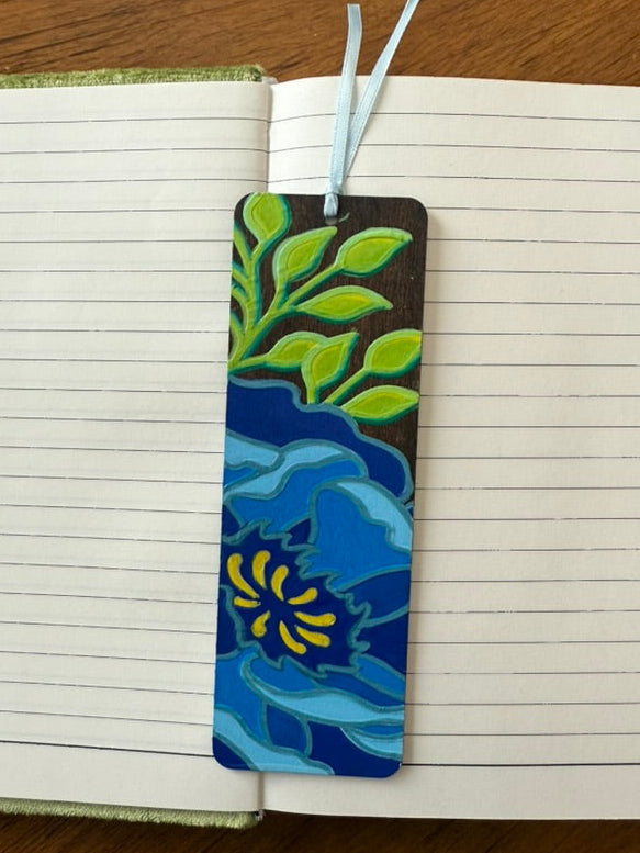 Decorative bookmark with floral design on a notebook page