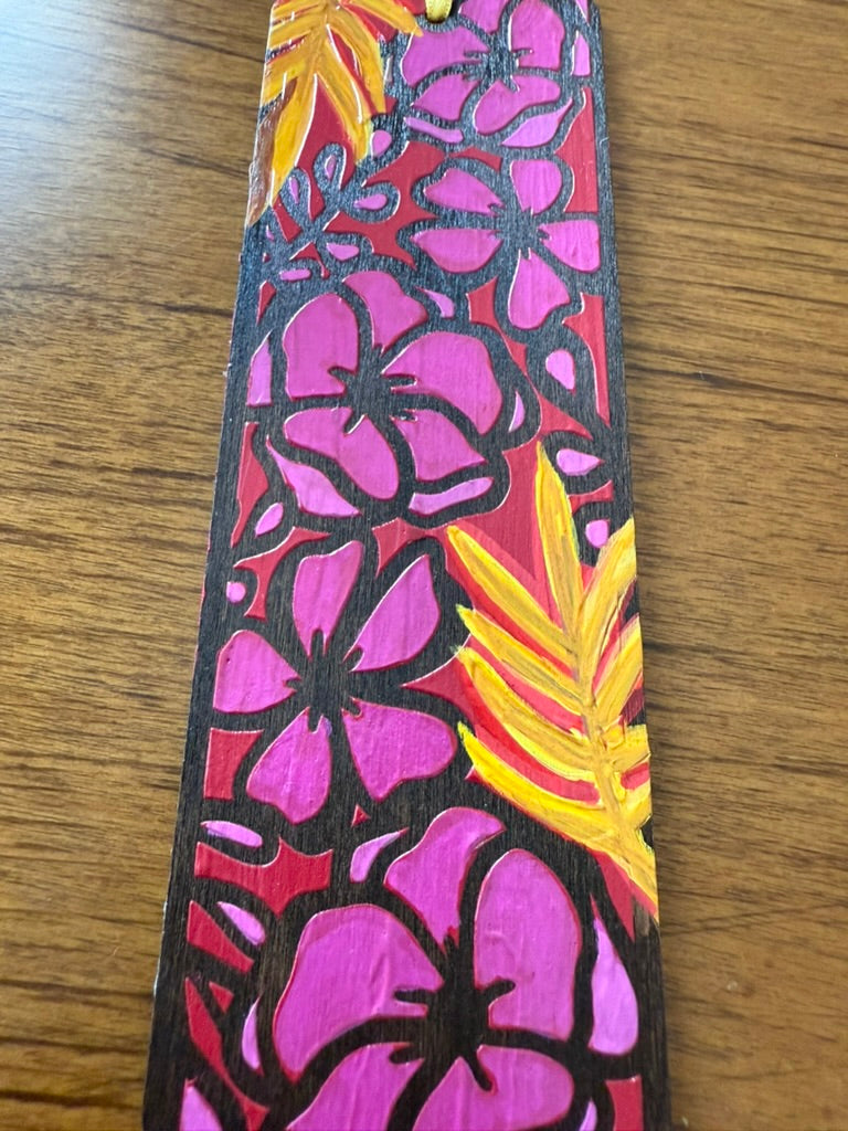 Floral patterned strap with pink flowers and yellow leaves on a wooden surface
