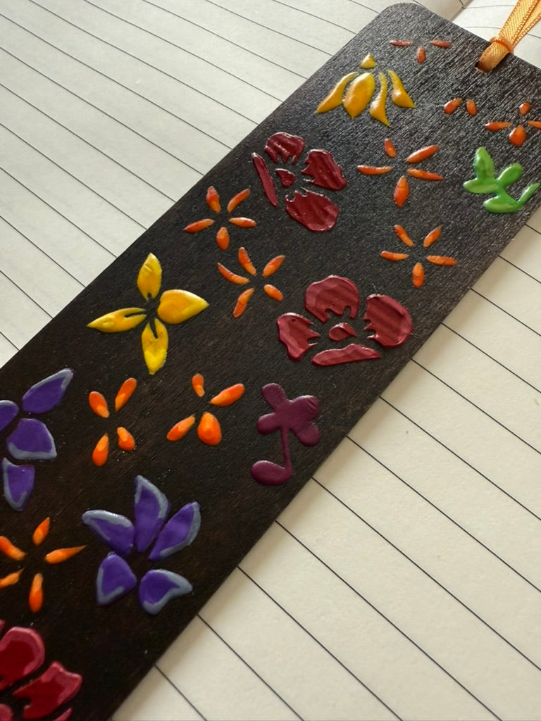 Decorative bookmark with colorful floral designs on a lined paper background
