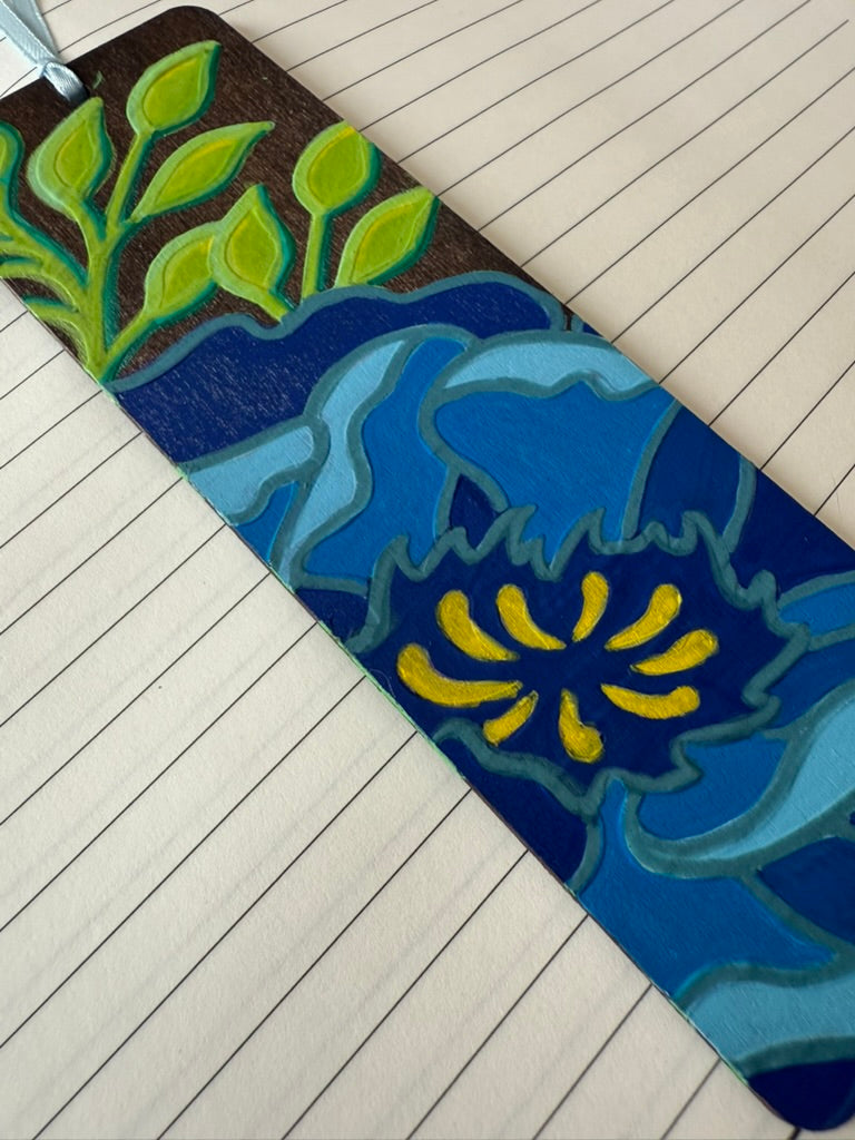 Decorative bookmark with floral pattern on a wooden floor