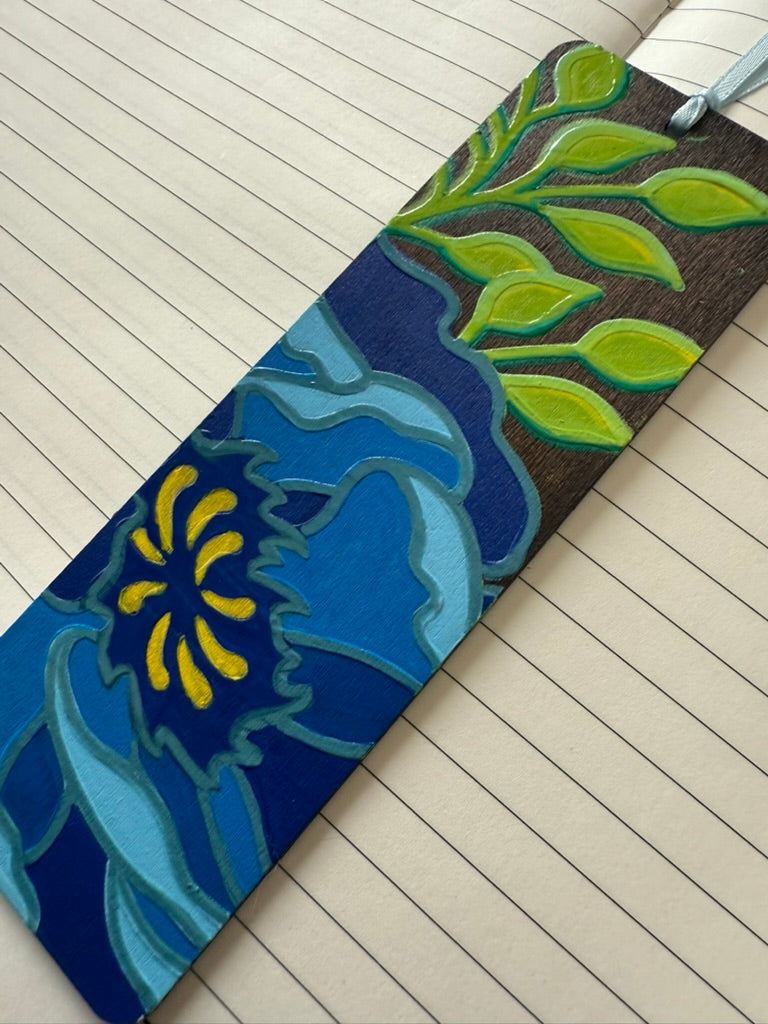 bookmark with blue and green design on a wooden floor