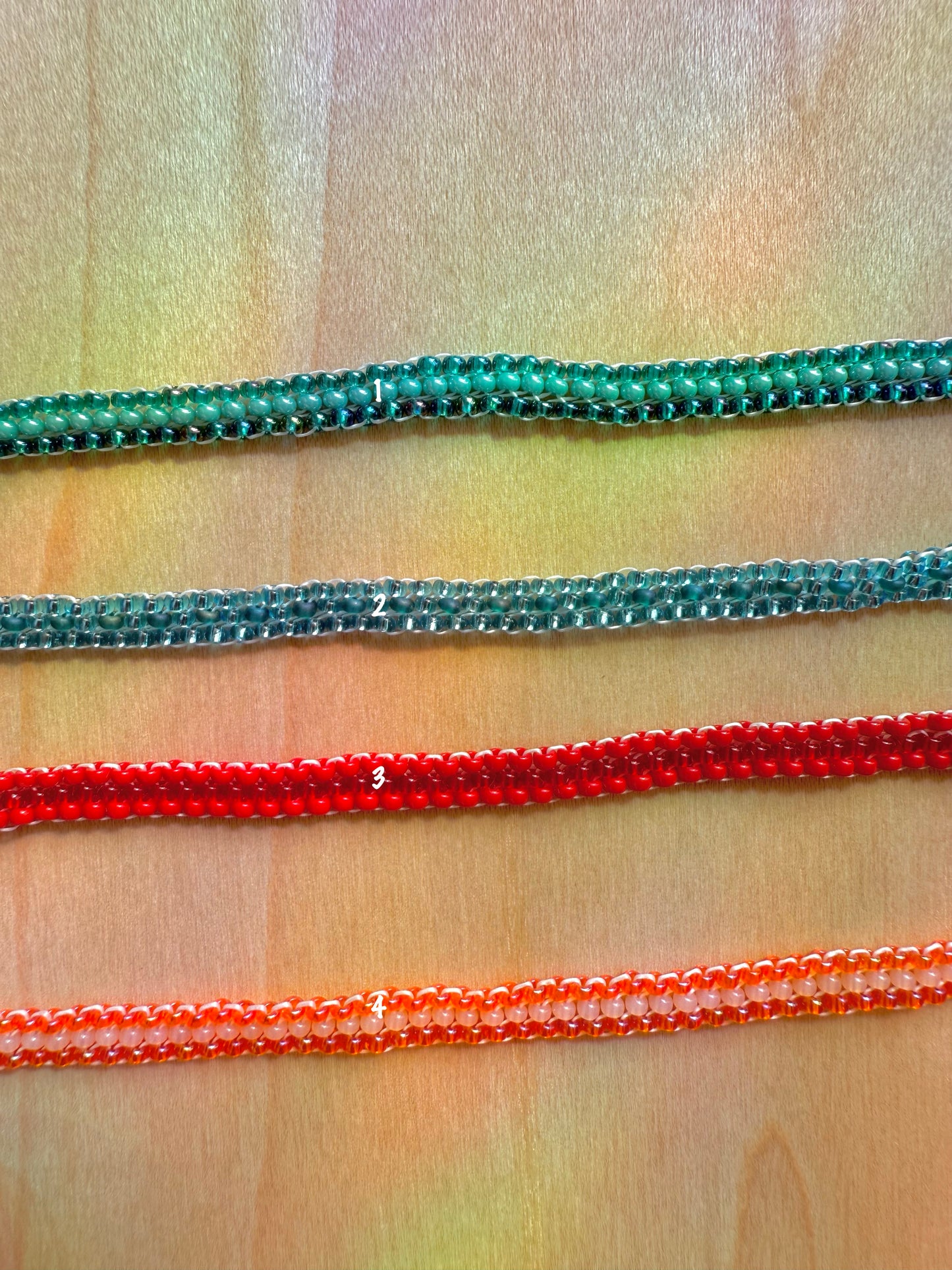 Three colorful zippers on a patterned fabric background