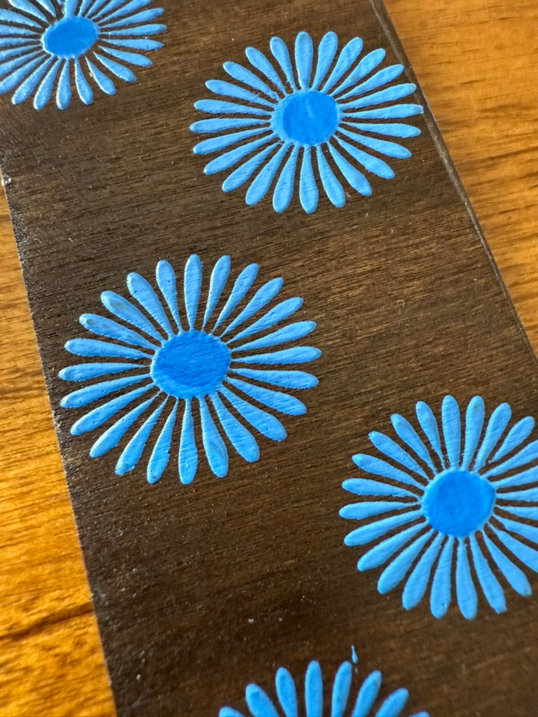Blue floral patterns on a brown surface