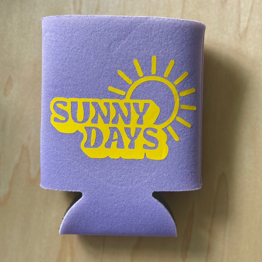 Purple can cooler with 'Sunny Days' text and sun graphic on a wooden surface
