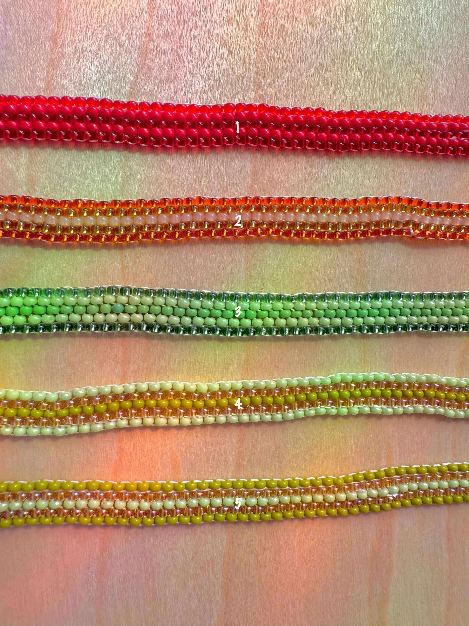 Close-up of colorful beaded bracelets on a fabric background