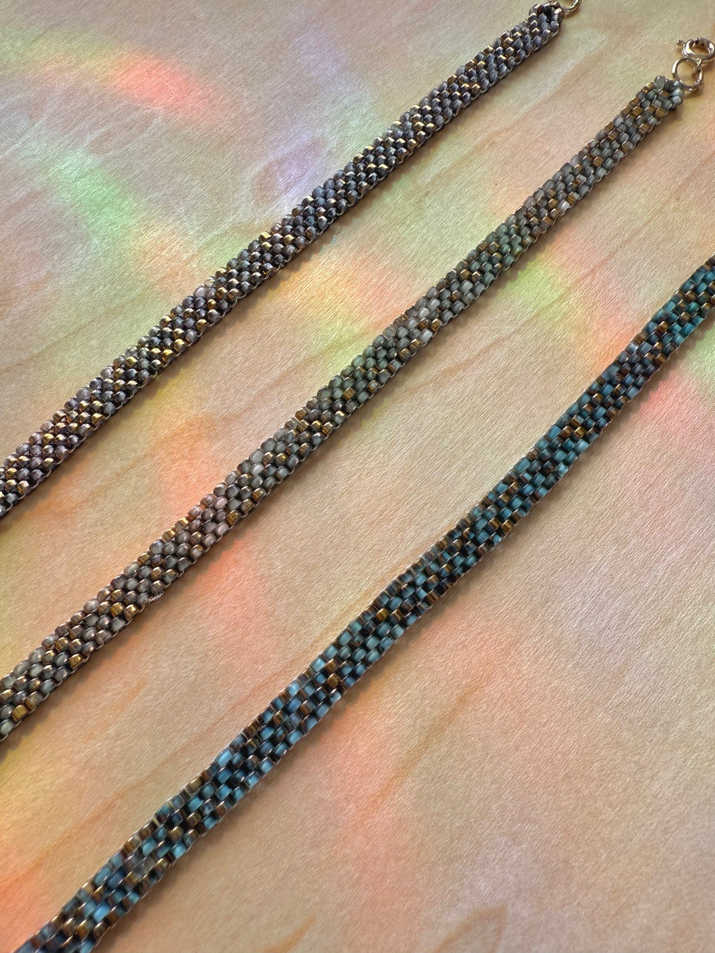 Close-up of a beaded necklace on a textured surface