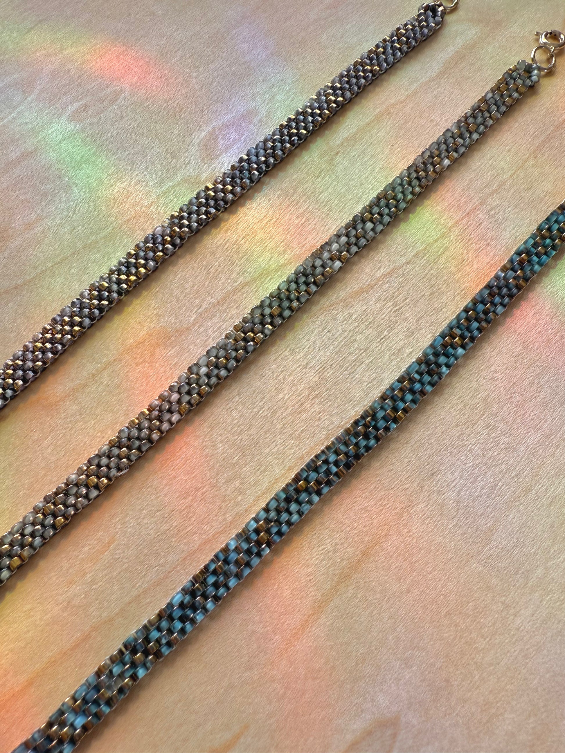 Close-up of a beaded necklace on a textured surface