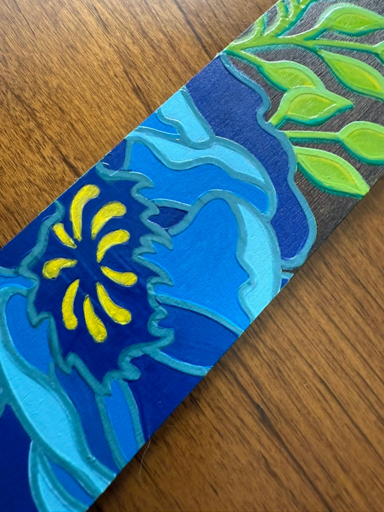 Colorful abstract design on a wooden bookmark
