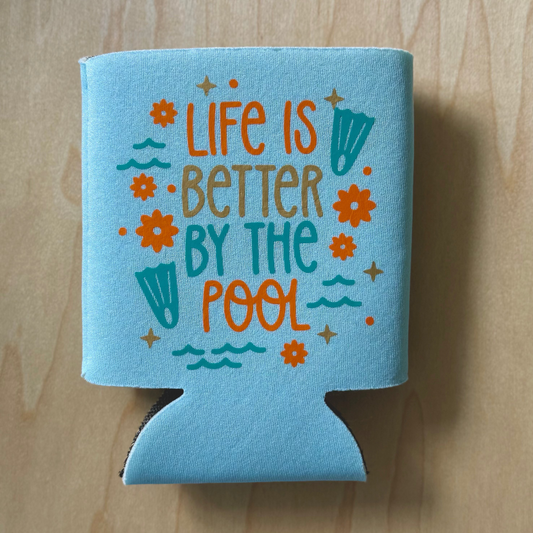 Blue can cooler with 'Life is Better by the Pool' text on a wooden surface