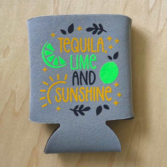 Gray can cooler with 'Tequila Lime and Sunshine' text on a wooden surface