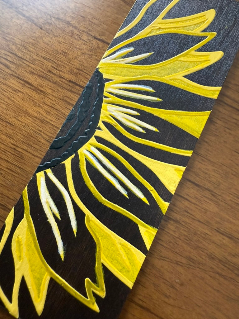 Black and yellow patterned object on a wooden surface
