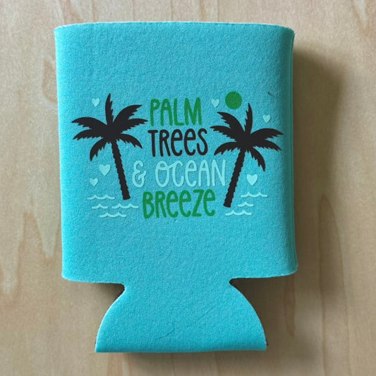 Turquoise can cooler with palm tree and ocean breeze design on a wooden surface