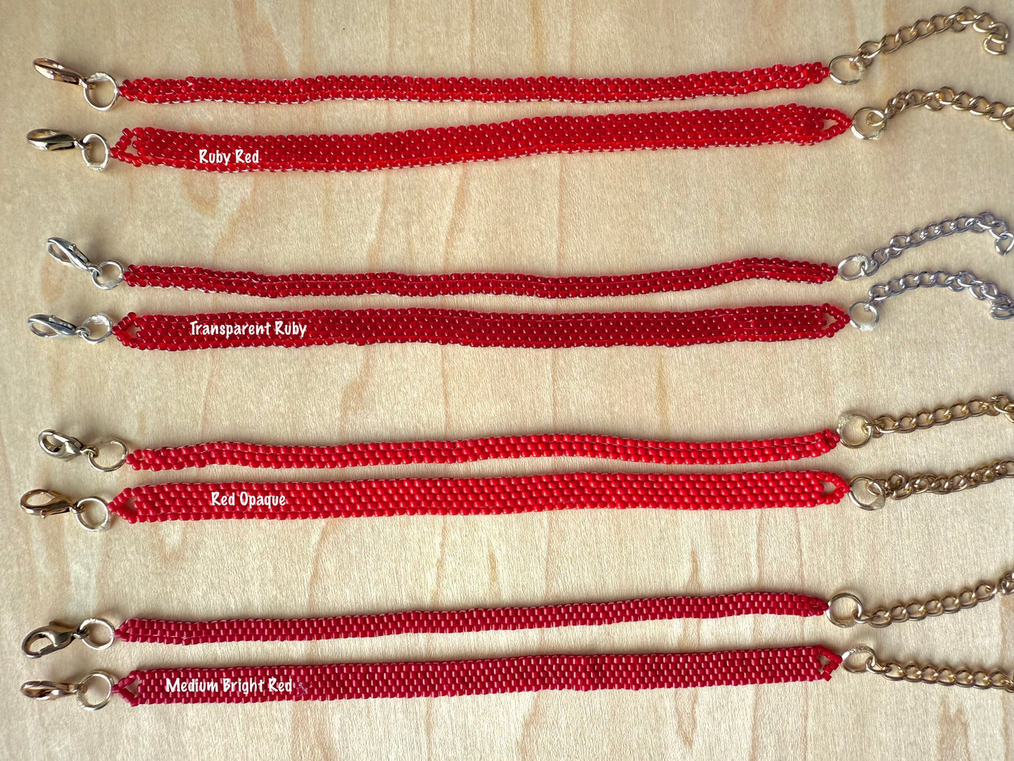 Red lanyards with metal clasps on a beige background